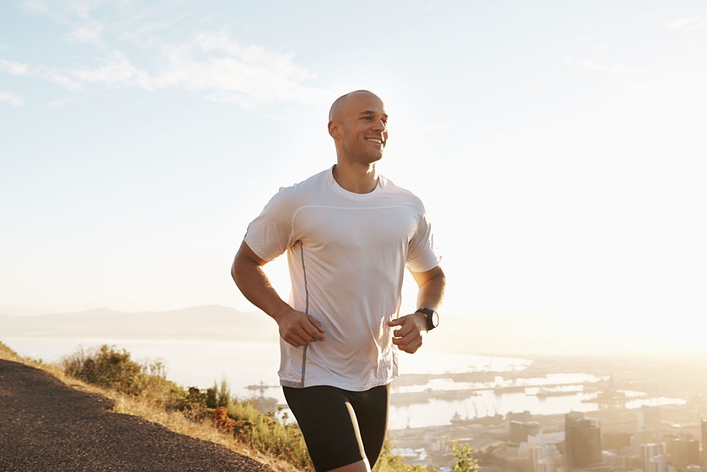 Shot of a young male runner training outdoors.