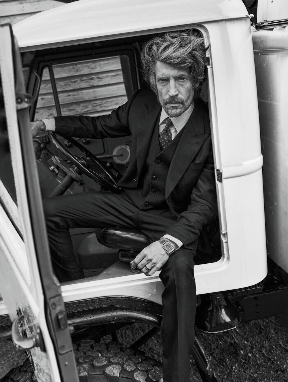 Suit, vest, and tie by Louis Vuitton Men’s; Reverso Tribute Duoface Calendar watch ($29,400) by Jaeger-LeCoultre; ring ($2,040) by Bulgari.