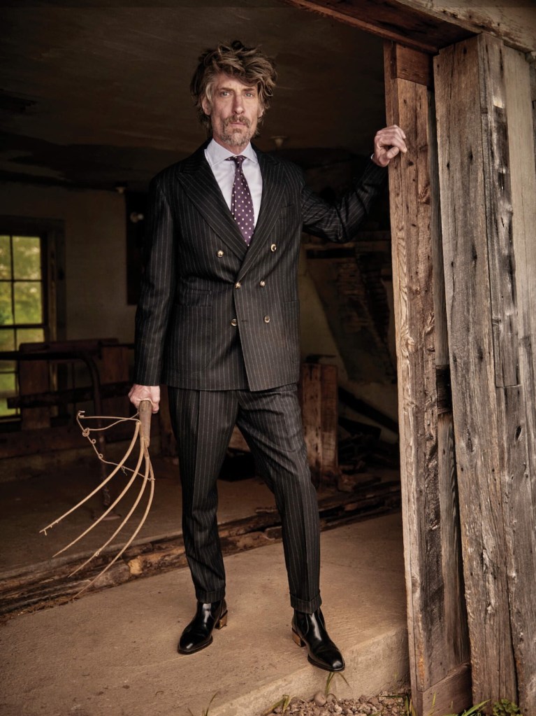 Suit ($6,095), shirt ($595), and tie ($295) by Brunello Cucinelli; boots ($1,250) by Giuseppe Zanotti.