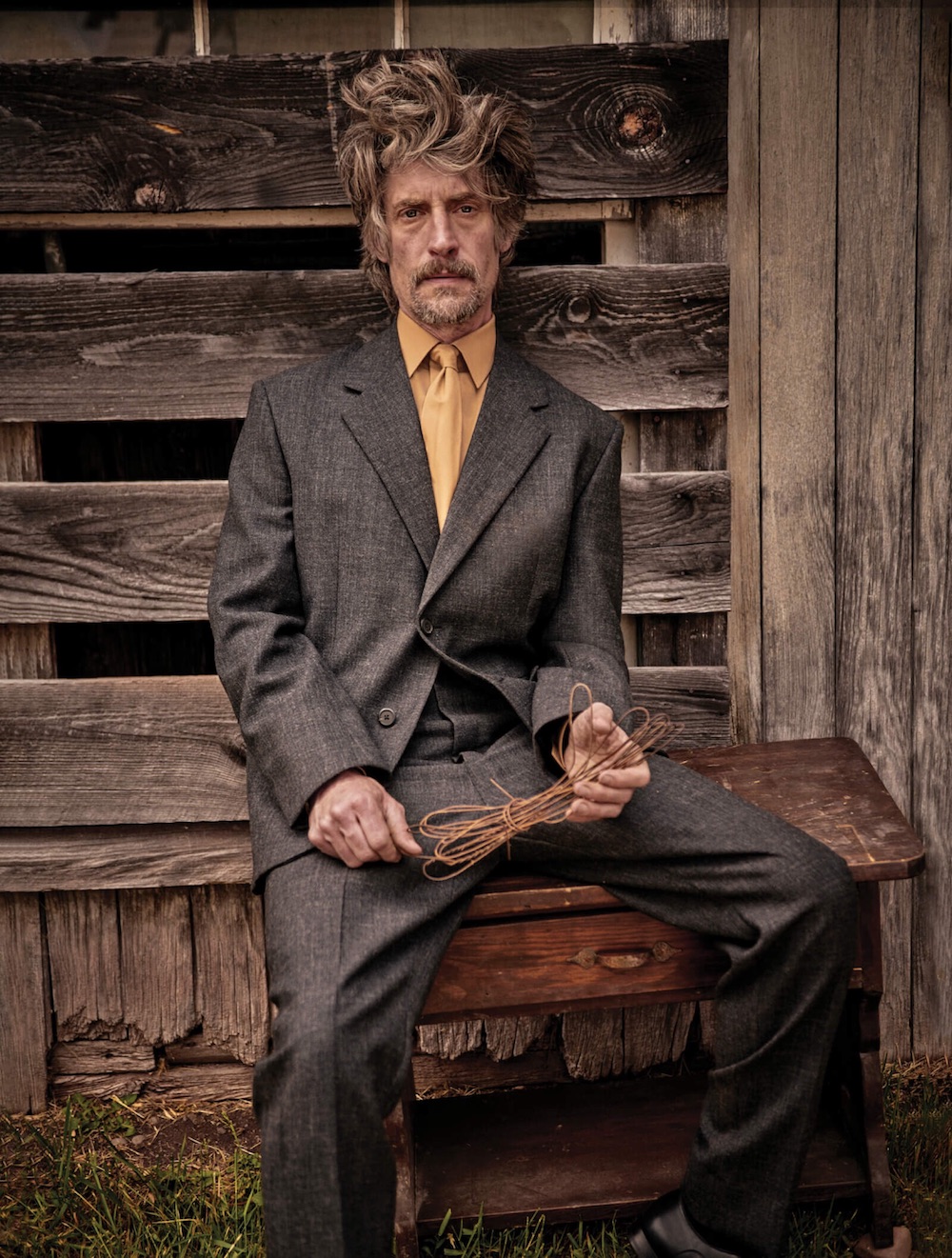 Jacket ($4,600), shirt, trousers ($1,420), tie, and shoes ($1,220) by Prada.