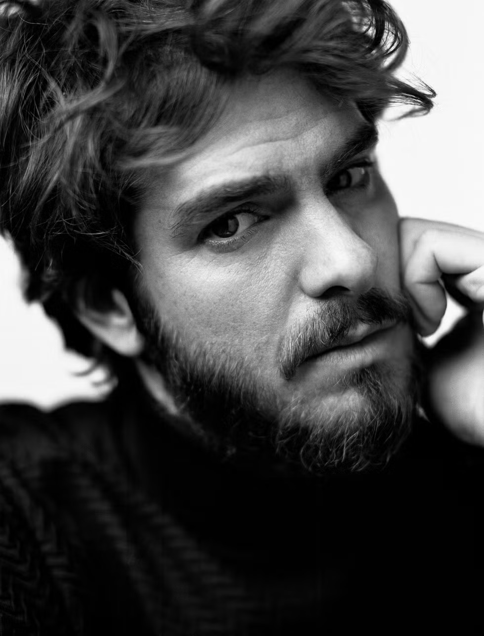 Andrew Garfield discusses his evolving career, exploring his roles in ‘We Live in Time’ and ‘Spider-Man,’ and the personal challenges and joys of balancing fame and artistry.